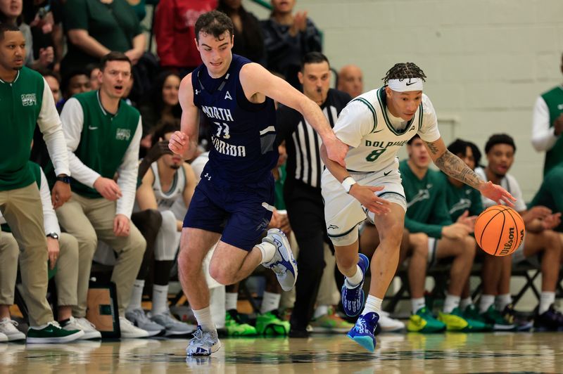 North Florida guard Oscar Berry (33) defends against Jacksonville guard Jakari Spence (8) during the first half of an NCAA men’s basketball matchup on Feb. 1.