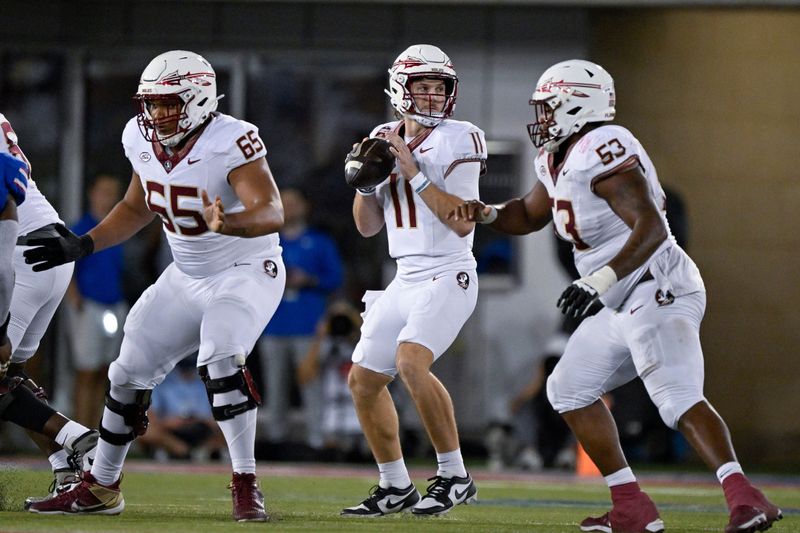 Sep 28, 2024; Dallas, Texas, USA; Florida State Seminoles quarterback Brock Glenn (11) drops back to pass between offensive lineman Andre Otto (65) and offensive lineman Maurice Smith (53) during the second half at Gerald J. Ford Stadium. Mandatory Credit: Jerome Miron-Imagn Images