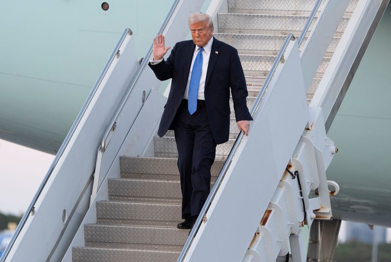 President Donald Trump waves after arriving on Air Force One at Palm Beach International Airport on Feb. 7, 2025.