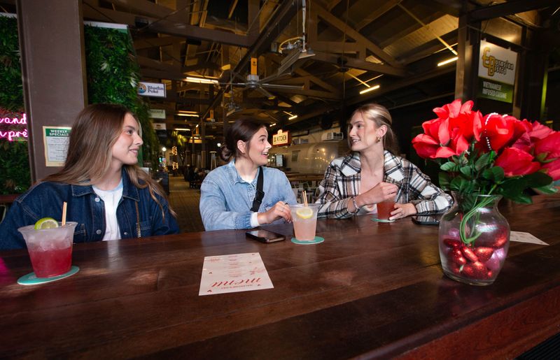 From left, Brittney Valentine, Kenzie Nemitz, and Claire Burak have Galentine's Day cocktails at the Perennial Patio Bar in downtown Pensacola on Saturday, Feb. 8, 2025.