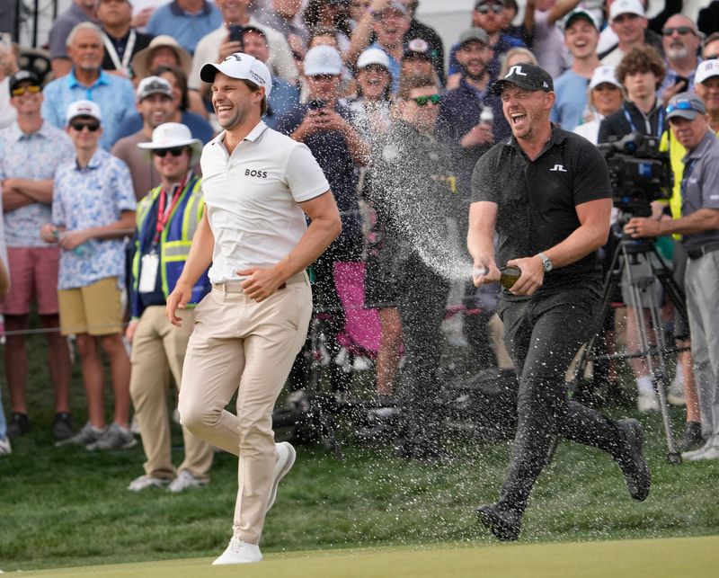 Thomas Detry is sprayed by fellow golfer Matt Wallace after winning the WM Phoenix Open at TPC Scottsdale on Sunday, Feb. 9, 2025.