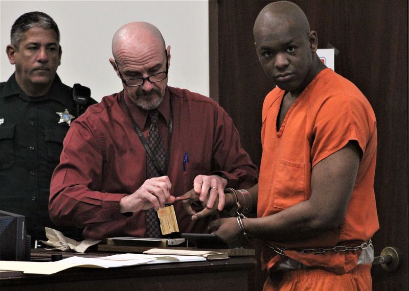 Dougnitrio D. Smith Jr., 26, is fingerprinted during a hearing on Friday, Feb. 7, 2025, at the S. James Foxman Justice Center in Daytona Beach. Smith is charged in the slaying of Elizabeth Adams, 67, in Port Orange in 2020. The state is seeking the death penalty.