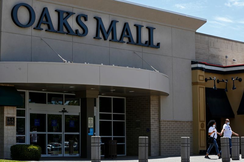 People leave The Oaks Mall in Gainesville, Fla. on April 9, 2020.