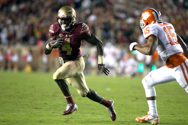 Oct 29, 2016; Tallahassee, FL, USA; Florida State Seminoles running back Dalvin Cook (4) outruns Clemson linebacker Korrin Wiggins (15) at Doak Campbell Stadium. Clemson won 37-34. Mandatory Credit: Glenn Beil-USA TODAY Sports