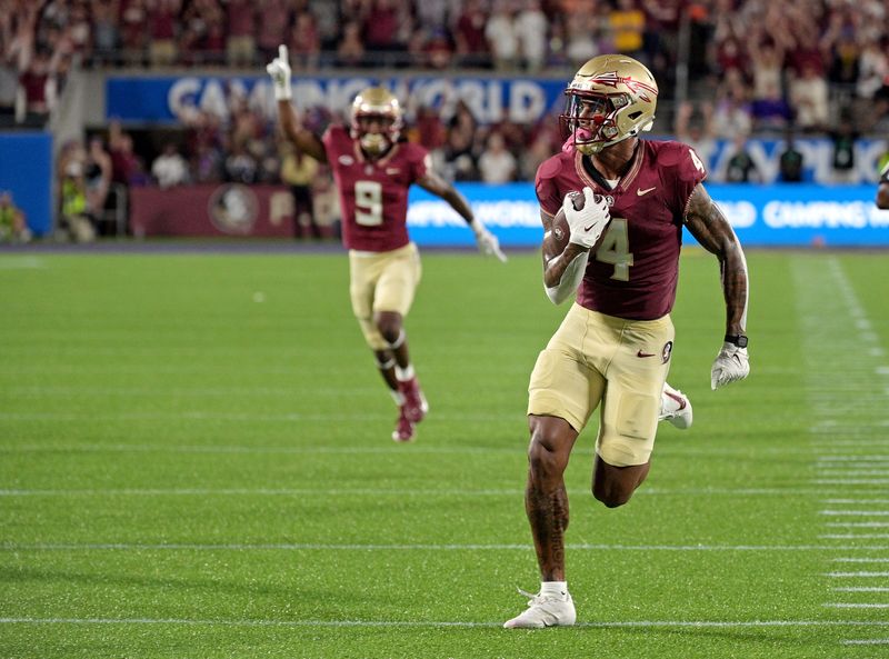 Sep 3, 2023; Orlando, Florida, USA; Florida State Seminoles wide receiver Keon Coleman (4) runs the ball for a touchdown during the first half against the Louisiana State Tigers at Camping World Stadium. Mandatory Credit:
Melina Myers-USA TODAY Sports