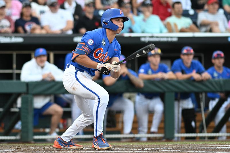 Jun 19, 2024; Omaha, NE, USA; Florida Gators shortstop Colby Shelton (10) doubles against the Texas A&M Aggies during the second inning at Charles Schwab Field Omaha. Mandatory Credit: Steven Branscombe-USA TODAY Sports