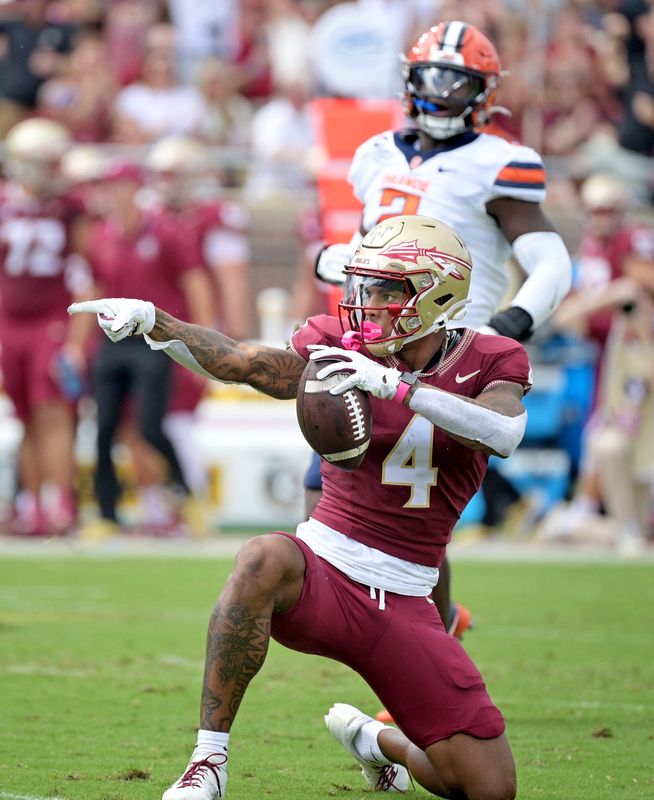 Oct 14, 2023; Tallahassee, Florida, USA; Florida State Seminoles wide receiver Keon Coleman (4) celebrates after catching a pass over Syracuse Orange defensive back Jason Simmons Jr. (6) (not pictured) during the first quarter at Doak S. Campbell Stadium. Mandatory Credit: 
Melina Myers-USA TODAY Sports