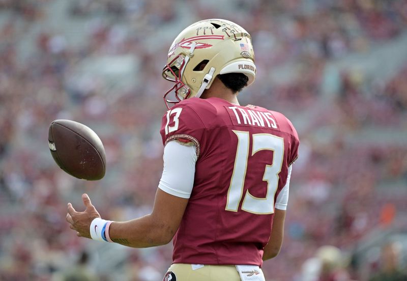 Nov 11, 2023; Tallahassee, Florida, USA; Florida State Seminoles quarterback Jordan Travis (13) takes a moment to himself before the game against the Miami Hurricanes at Doak S. Campbell Stadium. Mandatory Credit: Melina Myers-USA TODAY Sports