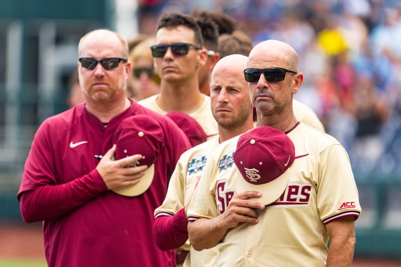 Jun 18, 2024; Omaha, NE, USA; Florida State Seminoles head coach Link Jarrett during the national anthem before the game against the North Carolina Tar Heels at Charles Schwab Field Omaha. Mandatory Credit: Dylan Widger-USA TODAY Sports