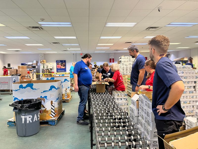 Volunteers pack food at the Harry Chapin Food Bank on June 4, 2024 in Naples.