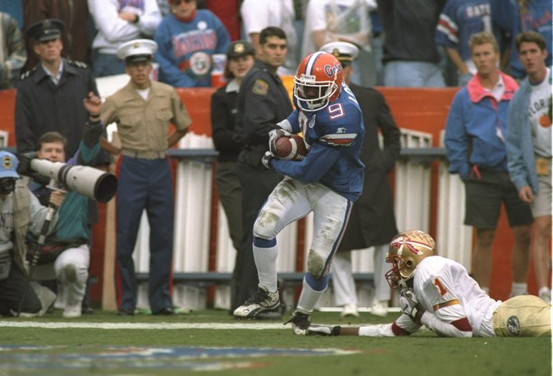 25 Nov 1995: Defensive back Anthone Lott of the Florida Gators breaks the tackle of Florida State Seminoles wide receiver Andre Cooper during a game at Florida Field in Gainesville, Florida. Florida won the game, 25-24. Mandatory Credit: Andy Lyons /Al