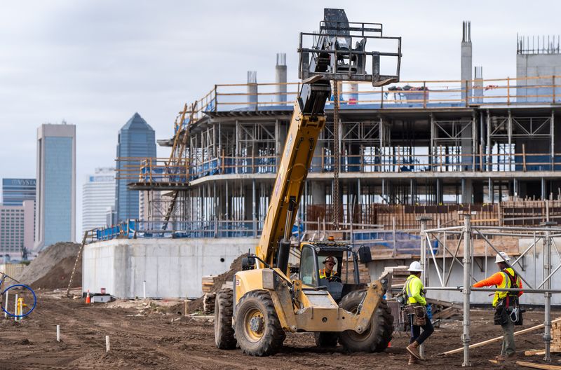 Construction workers prepare to moving scaffolding at the Four Seasons Hotel & Residences project in Jacksonville, Fla. [Doug Engle/Florida Times-Union]