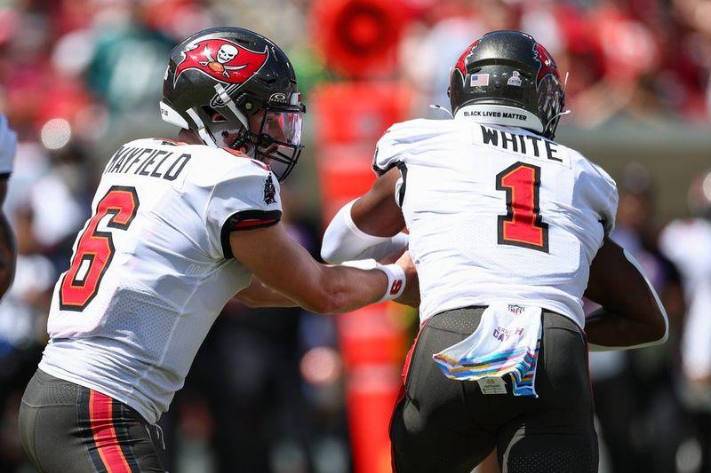 Sep 29, 2024; Tampa, Florida, USA; Tampa Bay Buccaneers quarterback Baker Mayfield (6) hands off to running back Rachaad White (1) against the Philadelphia Eagles in the first quarter at Raymond James Stadium. Mandatory Credit: Nathan Ray Seebeck-Imagn Images
