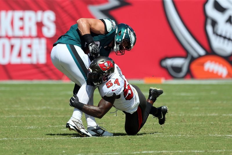 Sep 29, 2024; Tampa, Florida, USA; Tampa Bay Buccaneers linebacker Lavonte David (54) tackles Philadelphia Eagles tight end Dallas Goedert (88) during the first half at Raymond James Stadium. Mandatory Credit: Kim Klement Neitzel-Imagn Images