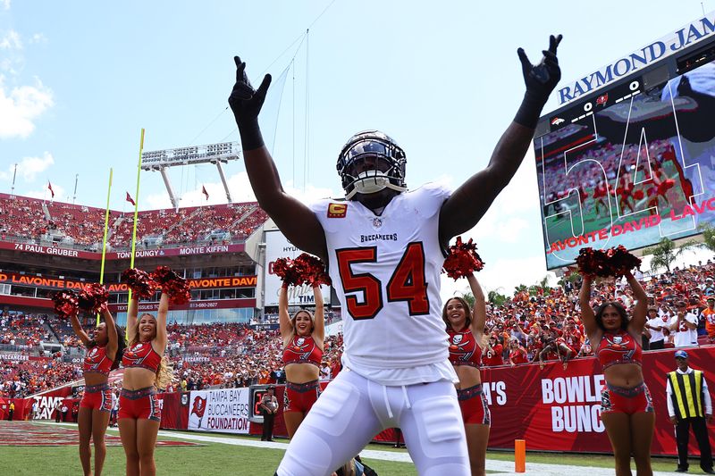 Sep 22, 2024; Tampa, Florida, USA; Tampa Bay Buccaneers linebacker Lavonte David (54) runs out of the tunnel as he is introduced before the game against the Denver Broncos at Raymond James Stadium. Mandatory Credit: Kim Klement Neitzel-Imagn Images