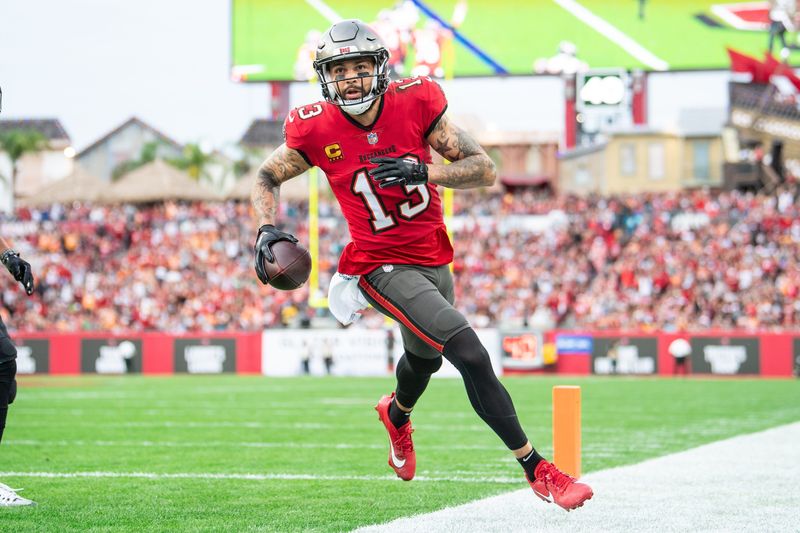 Dec 24, 2023; Tampa, Florida, USA;Tampa Bay Buccaneers wide receiver Mike Evans (13) catches the touchdown against the Jacksonville Jaguars in the second quarter at Raymond James Stadium. Mandatory Credit: Jeremy Reper-USA TODAY Sports