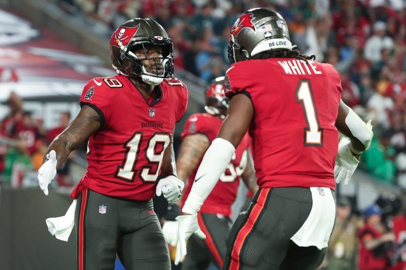 Jan 15, 2024; Tampa, Florida, USA; Tampa Bay Buccaneers wide receiver David Moore (19) celebrates his touchdown with running back Rachaad White (1) during the first half of a 2024 NFC wild card game against the Philadelphia Eagles at Raymond James Stadium. Mandatory Credit: Kim Klement Neitzel-USA TODAY Sports