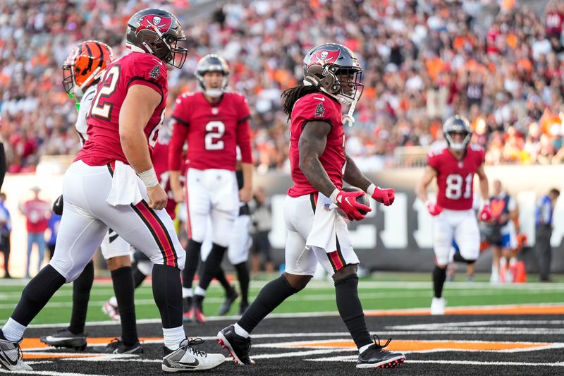 Tampa Bay Buccaneers running back Bucky Irving (7) celebrates a touchdown carry in the first quarter of the NFL Preseason Week 1 game between the Cincinnati Bengals and the Tampa Bay Buccaneers at Paycor Stadium in downtown Cincinnati on Saturday, Aug. 10, 2024.