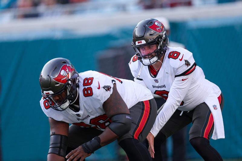 Aug 17, 2024; Jacksonville, Florida, USA; Tampa Bay Buccaneers guard Avery Jones (66) and quarterback Baker Mayfield (6) warm up before a preseason game against the Jacksonville Jaguars at EverBank Stadium. Mandatory Credit: Nathan Ray Seebeck-USA TODAY Sports