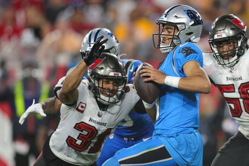 Dec 3, 2023; Tampa, Florida, USA; Carolina Panthers quarterback Bryce Young (9) is sacked by Tampa Bay Buccaneers safety Antoine Winfield Jr. (31) in the third quarter at Raymond James Stadium. Mandatory Credit: Nathan Ray Seebeck-USA TODAY Sports