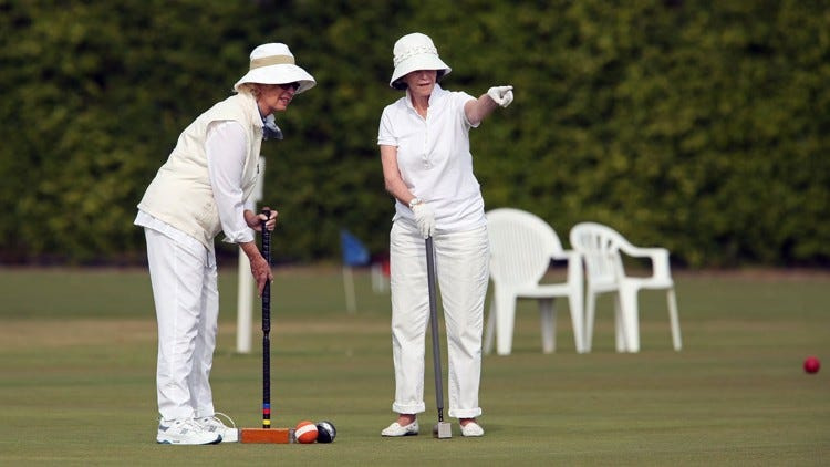 Two women participate in a novice tournament at the National Croquet Center.