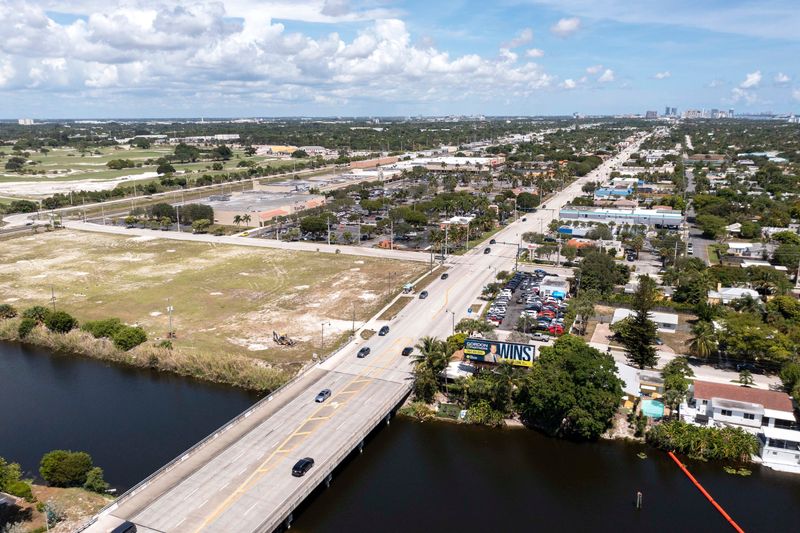 The vacant parcel at 8111 South Dixie Highway, the southern gateway of West Palm Beach, is being developed into apartments and an 'urban specialty grocer.' Speculation is that the grocer will be Trader Joe's.