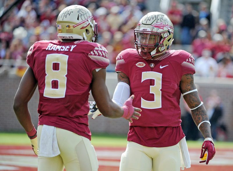 Nov 14, 2015; Tallahassee, FL, USA; Florida State University defensive back Jalen Ramsey (8) celebrates with defensive back Derwin James (3) after a defensive stop during the game against the North Carolina State Wolfpack at Doak Campbell Stadium. Mandatory Credit: Melina Vastola-USA TODAY Sports