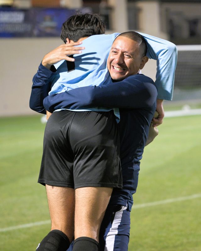 American Heritage's Victor Sanchez carries David Derk after a state championship win against Lake Highland Prep on Feb. 28, 2025.