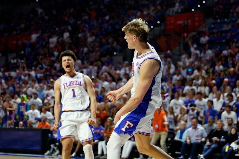 Mar 1, 2025; Gainesville, Florida, USA; Florida Gators forward Thomas Haugh (10) and guard Walter Clayton Jr. (1) react after a dunk against the Texas A&M Aggies during the second half at Exactech Arena at the Stephen C. O'Connell Center. Mandatory Credit: Morgan Tencza-Imagn Images