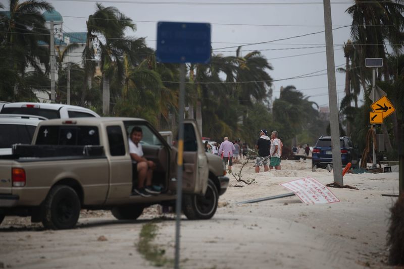 Boats, debris and sand cover Bonita Beach Road, which is closed as you approach the beach by Hickory Bay Boathouse. The storm surge from Hurricane Ian caused massive amounts of damage along the beach.