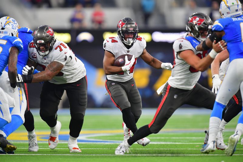 Dec 15, 2024; Inglewood, California, USA; Tampa Bay Buccaneers running back Sean Tucker (44) runs the ball against the Los Angeles Chargers during the second half at SoFi Stadium. Mandatory Credit: Gary A. Vasquez-Imagn Images