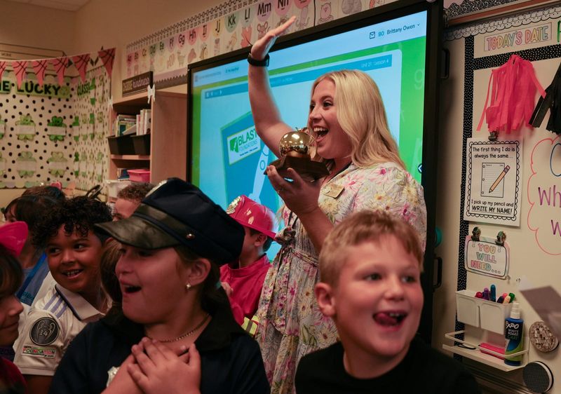 Brittany Owen, first grade general education teacher at Trafalgar Elementary in Cape Coral, gets a surprise visit and is presented with a Golden Apple award Friday morning March 7, 2025. Members of the Foundation for Lee County Public Schools surprised six teachers with the prestigious Golden Apple Award. The Golden Apple Teacher Recognition Program was created by the foundation to help enhance and enrich public education by recognizing and rewarding excellence in teaching.