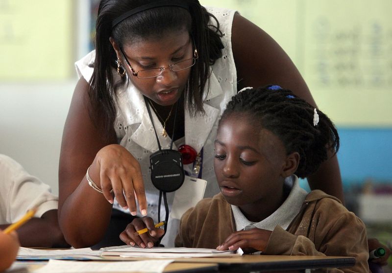 081910 (Bruce R. Bennett/The Palm Beach Post) WEST PALM BEACH - Teacher Jeannette Duggan (cq, left) works with third grader Belinda Bazile (cq, right) during class at Pleasant City Elementary School Thursday morning. SCR 2850