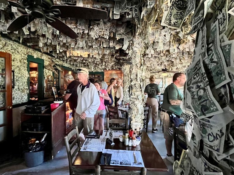 According to Cabbage Key owner Rob Wells, between $55,000 and $70,000 in dollar bills are hanging on walls and ceiling at any given time.