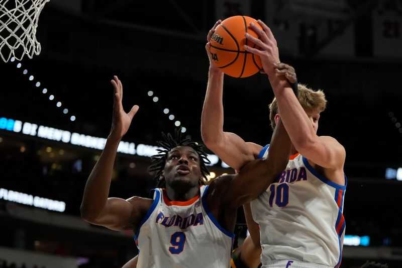 Mar 21, 2025; Raleigh, NC, USA; Florida Gators center Rueben Chinyelu (9) and forward Thomas Haugh (10) controls the ball during the first half against the Norfolk State Spartans at Lenovo Center. Mandatory Credit: Bob Donnan-Imagn Images