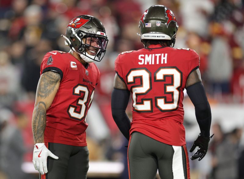 Jan 12, 2025; Tampa, Florida, USA; Tampa Bay Buccaneers safety Antoine Winfield Jr. (31) and Tampa Bay Buccaneers safety Tykee Smith (23) warm up before a NFC wild card playoff against the Washington Commanders at Raymond James Stadium. Mandatory Credit: Nathan Ray Seebeck-Imagn Images