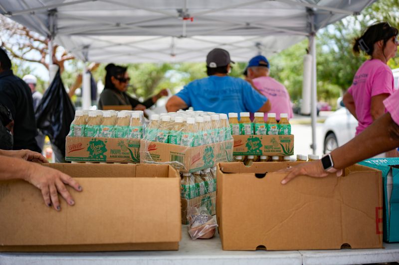 Meals of Hope volunteers help operate a mobile food pantry near the Golden Gate Public Library in Naples, Fla., on Thursday, April 3, 2025.