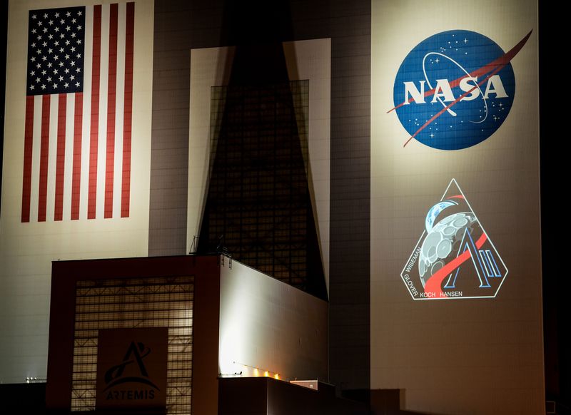 The insignia for the Artemis II mission is projected onto the Vehicle Assembly Building at Kennedy Space Center, FL Thursday, April 3, 2025. The mission logo was unveiled in advance of the launch, which will take four astronauts around the moon. Craig Bailey/FLORIDA TODAY via USA TODAY NETWORK