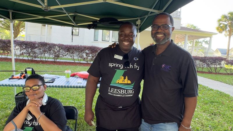 Pastor/former Mayor John Christian (right) with Fred Griffin and Leesburg Chamber's Chevone Pemberton at Leesburg Fish Fry, April 3, 2025