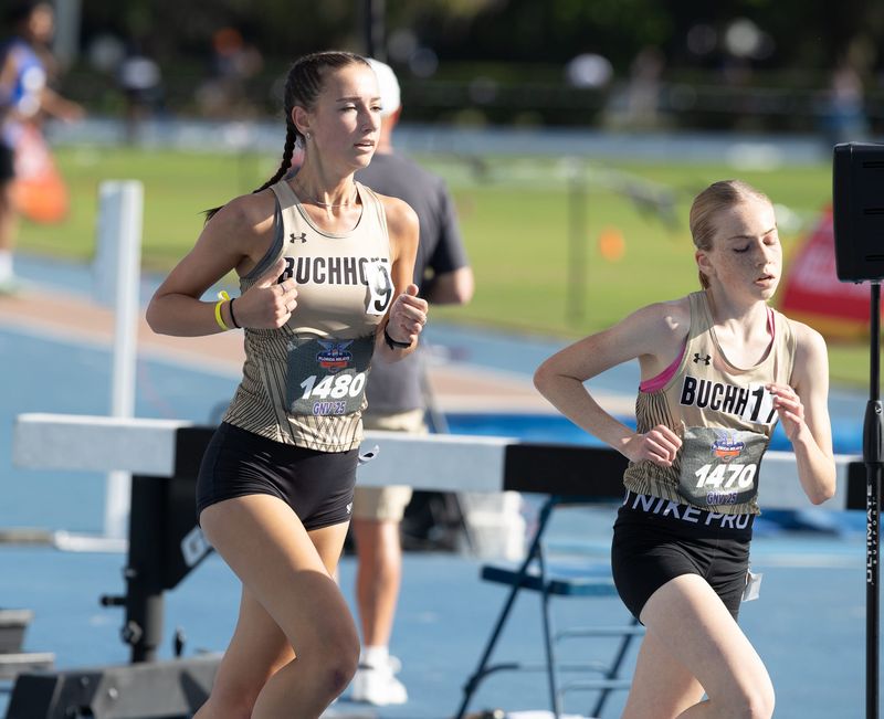 Buchholz’s Elenor Whistler, left and Alanna Doyle compete in the 3200m heat during the Pepsi Florida Relays at Percy Beard Track in Gainesville, FL on Friday, April 4, 2025. [Alan Youngblood/Gainesville Sun]