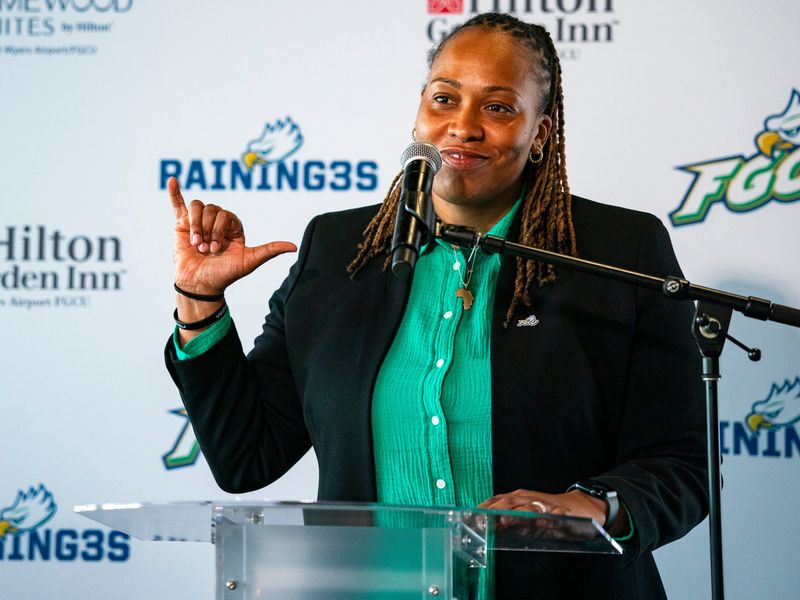 Raina Harmon throws a "Wings Up" as she's introduced as the new head coach for Florida Gulf Coast's women's basketball team at The Boardwalk restaurant in Fort Myers, Fla., on Tuesday, April 8, 2025.