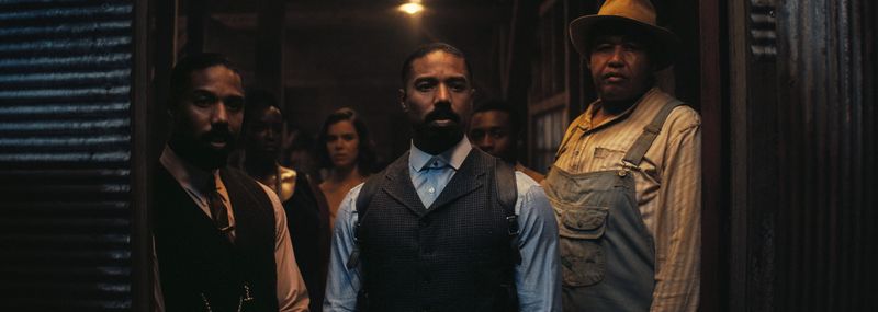 Smoke (Michael B. Jordan, center), flanked by brother Stack (also Jordan) and pal Cornbread (Omar Benson Miller), is wary of uninvited guests in the period horror film "Sinners."