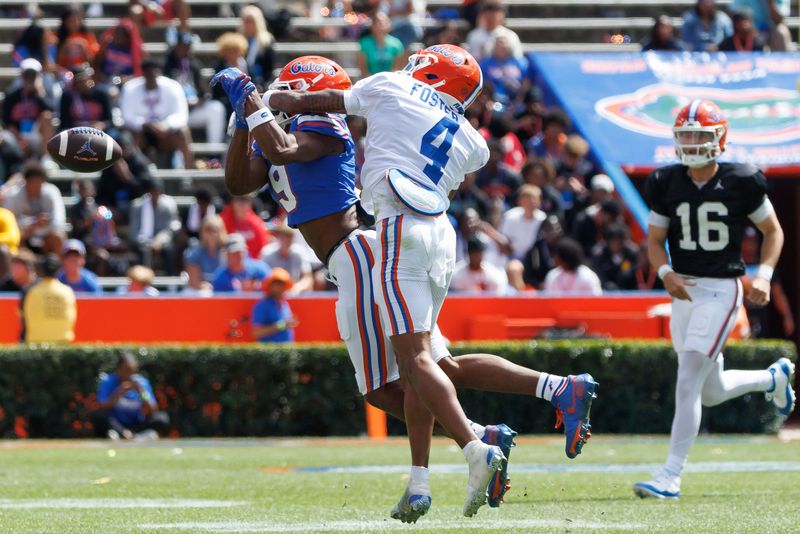 Apr 12, 2025; Gainesville, FL, USA; Florida Gators defensive back Teddy Foster (4) breaks up a pass to Florida Gators wide receiver J. Michael Sturdivant (9) during the second half at Ben Hill Griffin Stadium. Mandatory Credit: Matt Pendleton-Imagn Images