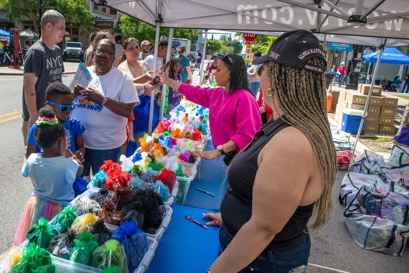 Visitors check out the festivities during Fred Levin Way Fest in Downtown Pensacola Sunday, April 13, 2025 The fest included kids activities, food trucks, free museum entry, free essential items and community assistance and more.