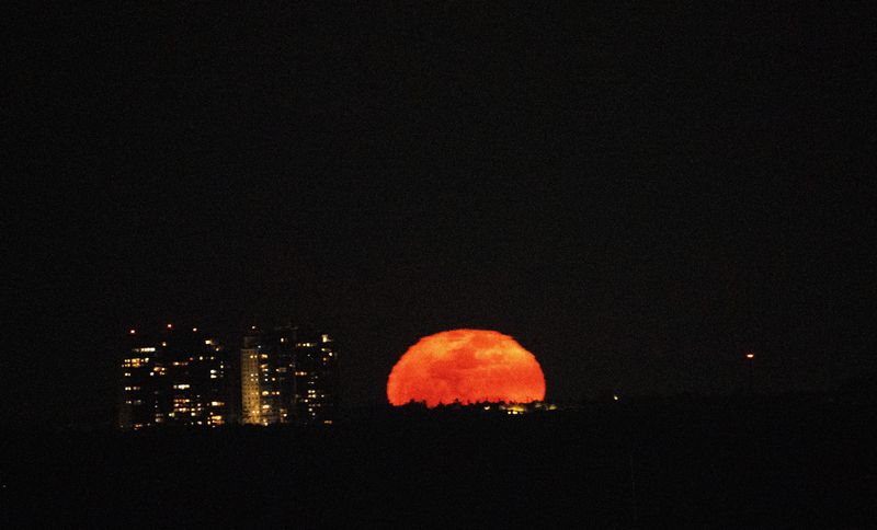 An almost full moon rises over Fort Myers Beach on Sunday, April 13, 2025. The full moon was on Saturday evening and was called the “Pink moon.”