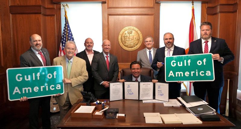 From left, state senators Keith Truenow, Don Gaetz, Blaise Ingoglia, Nick DiCeglie, Gov. Ron DeSantis (seated), state senators Stan McClain, Joe Gruters and Jonathan Martin attend the bill signing for measures changing the name to Gulf of America in Florida.