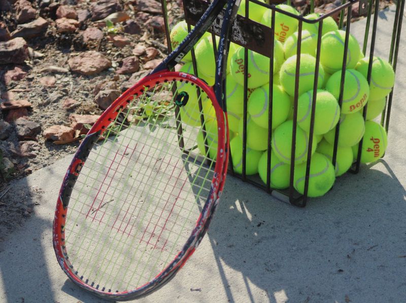 STOCK | A tennis racket and tennis balls rest alongside the court during an FHSAA District 3-1A high school girls tennis match in Jacksonville, Florida, on April 14, 2025. [Clayton Freeman/Florida Times-Union]