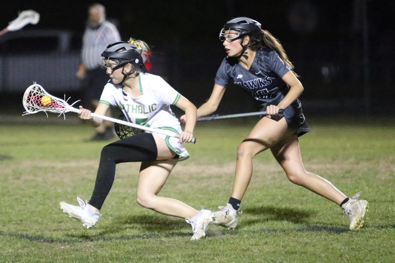Pensacola Catholic's Ella Adams (15) sneaks around the South Walton defense during the Crusaders' District 1-1A championship win over South Walton on Tuesday, April 15, 2025, at Pensacola Catholic High School.