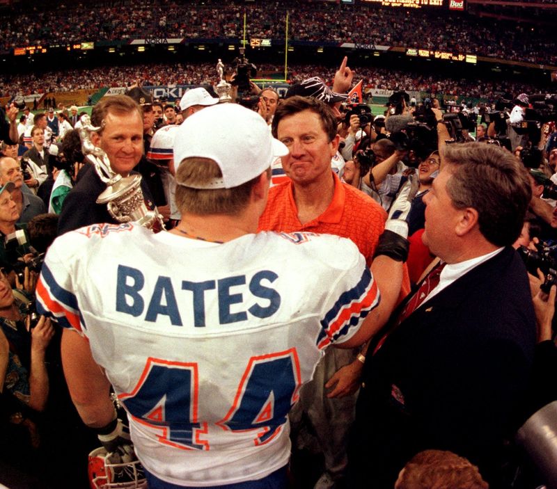 UF head coach Steve Spurrier hugs senior line backer James Bates after the Gator win over FSU in the Sugar Bowl.