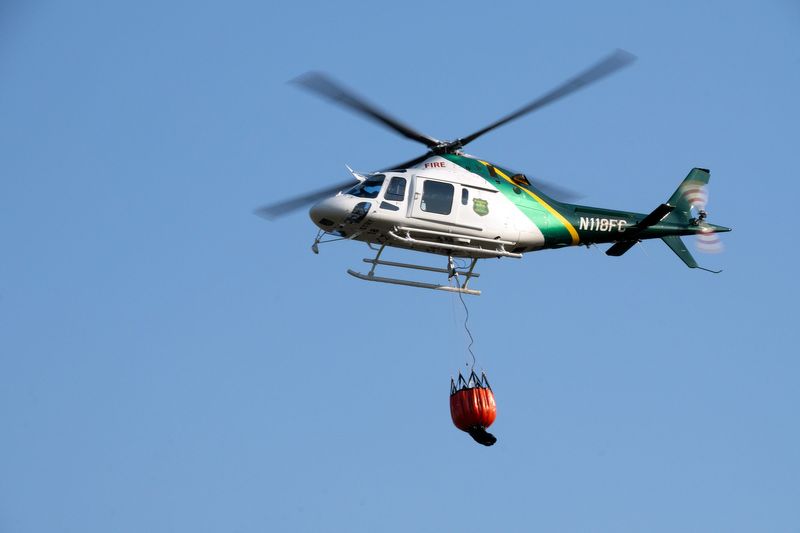A helicopter responds to the Clayton Road Fire on April 17, 2025 near Econfina, Florida.